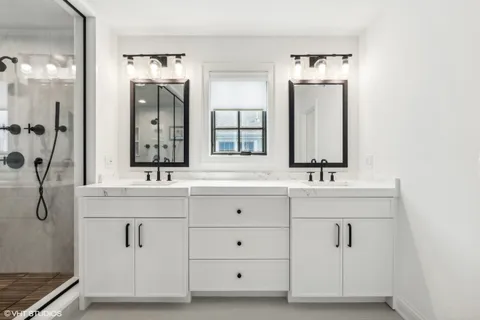 a bathroom with a granite countertop sink mirror and shower