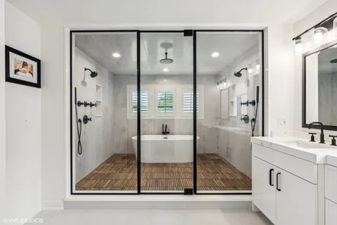 a bathroom with a double vanity sink mirror and shower