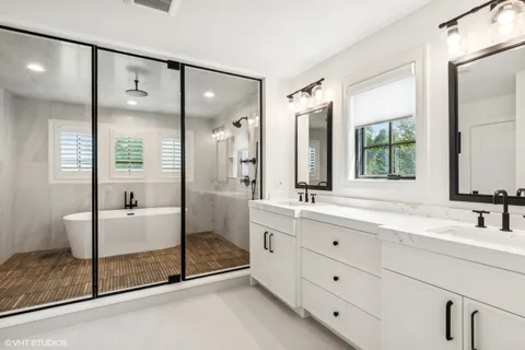 a bathroom with a double vanity sink and a mirror