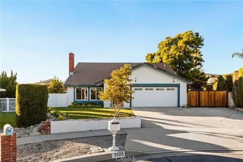 a view of swimming pool with a house in the background