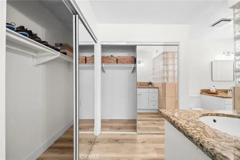 a en suite bathroom with a granite countertop double vanity and a shower