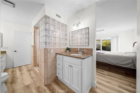 a bathroom with a granite countertop sink a shower and a mirror