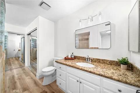 a view of a hallway view with wooden floor and furniture