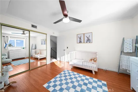 a bedroom with furniture and wooden floor