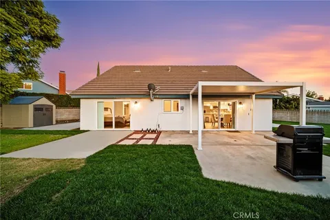 a backyard of a house with table and chairs