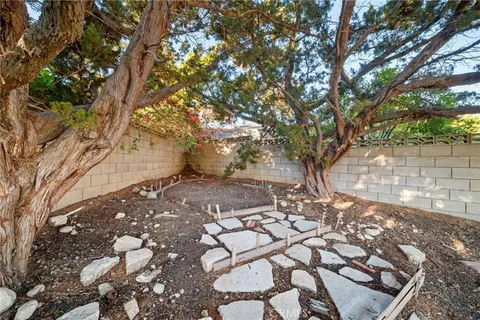 an aerial view of residential houses with outdoor space and trees