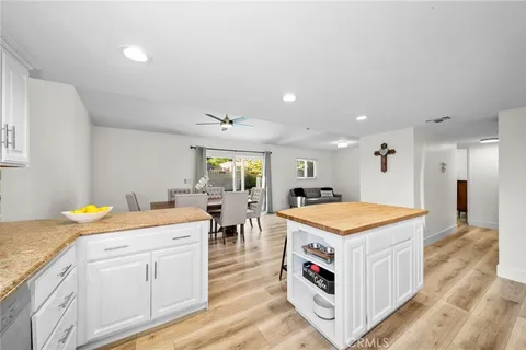 a kitchen with a sink a stove a refrigerator and white cabinets