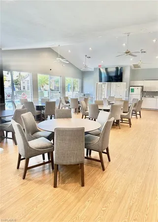 a dining room with furniture a rug and a large window