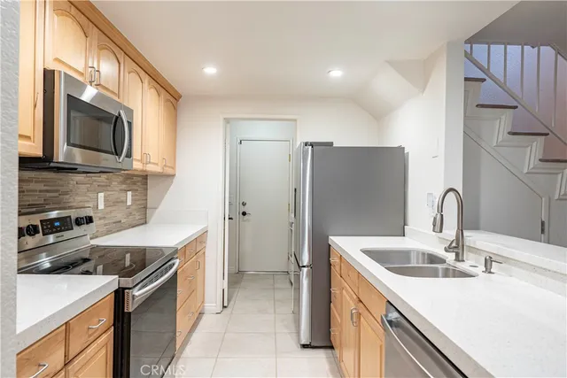 a kitchen with a sink and refrigerator