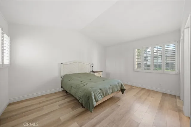 a view of a big room with wooden floor and windows