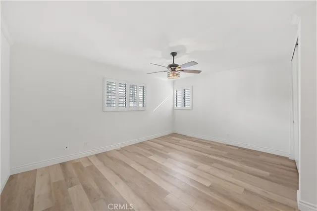 a view of a room with a fan and a window