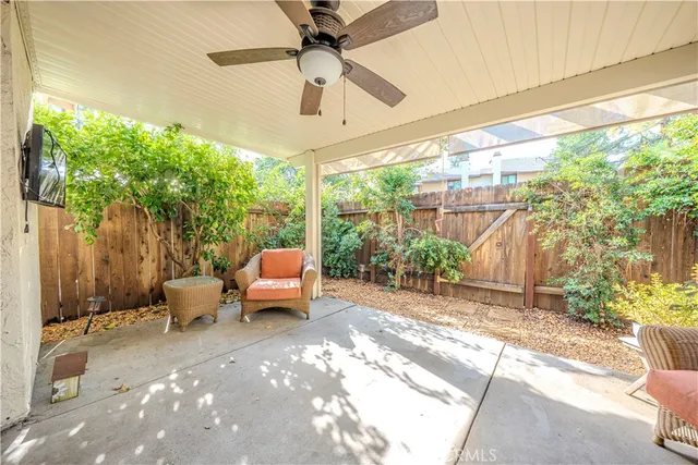 a view of a porch with furniture and a yard