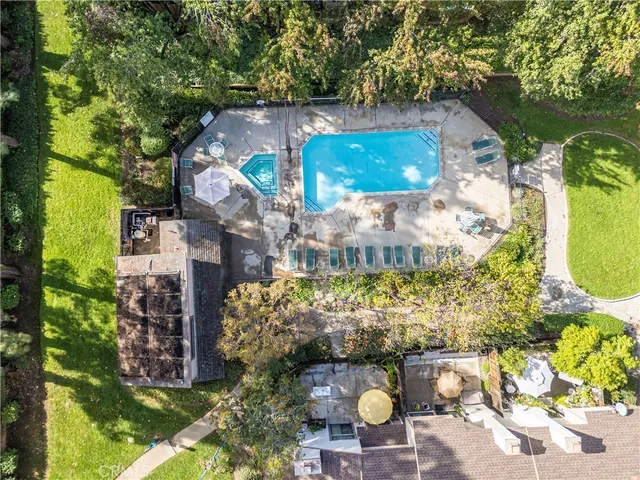 an aerial view of a residential houses with outdoor space