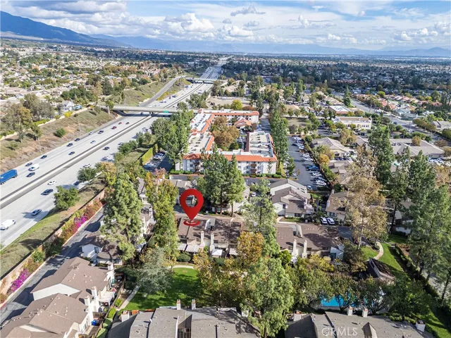 an aerial view of house with yard and ocean view