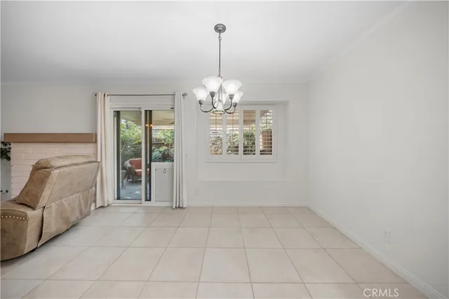 a view of a livingroom with a window and chandelier
