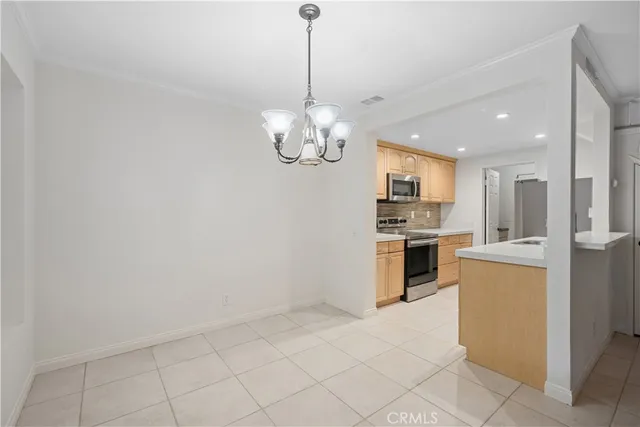 a kitchen with stainless steel appliances granite countertop a sink a stove and a microwave