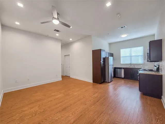 a view of a livingroom with furniture and stainless steel appliances