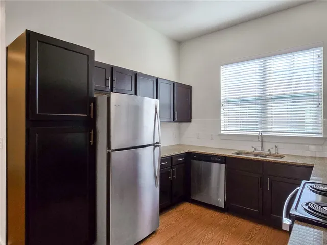 a kitchen with a sink a refrigerator a washer and dryer