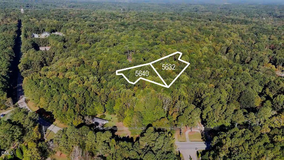 an aerial view of a house with a yard and street