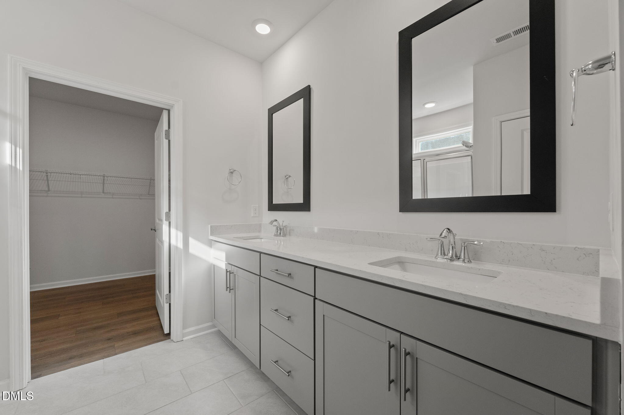 1639 Abberly Place Graham, NC 27253 - Photo 17 of 43 a bathroom with a double vanity sink and mirror