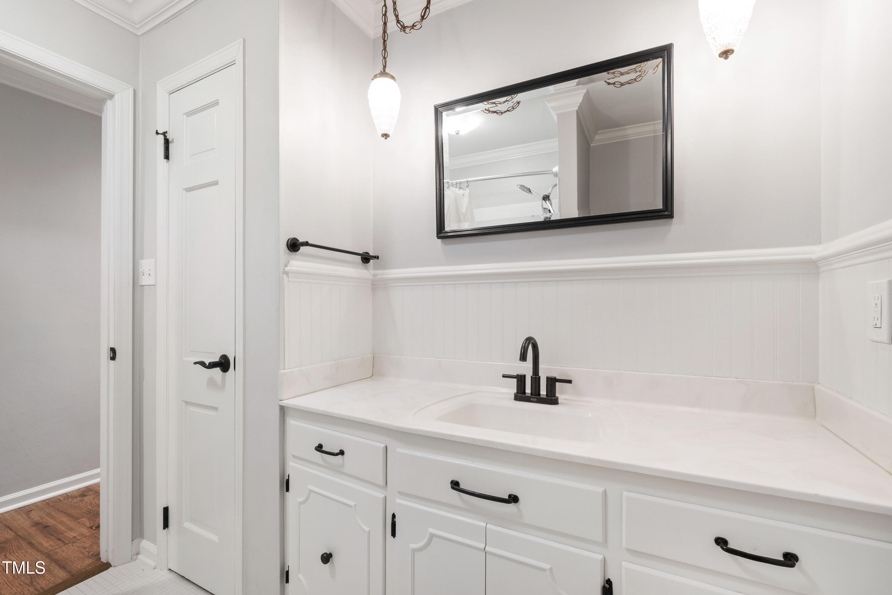 3209 Caldwell Drive Raleigh, NC 27607 - Photo 31 of 42 a bathroom with a sink a mirror a vanity and shower