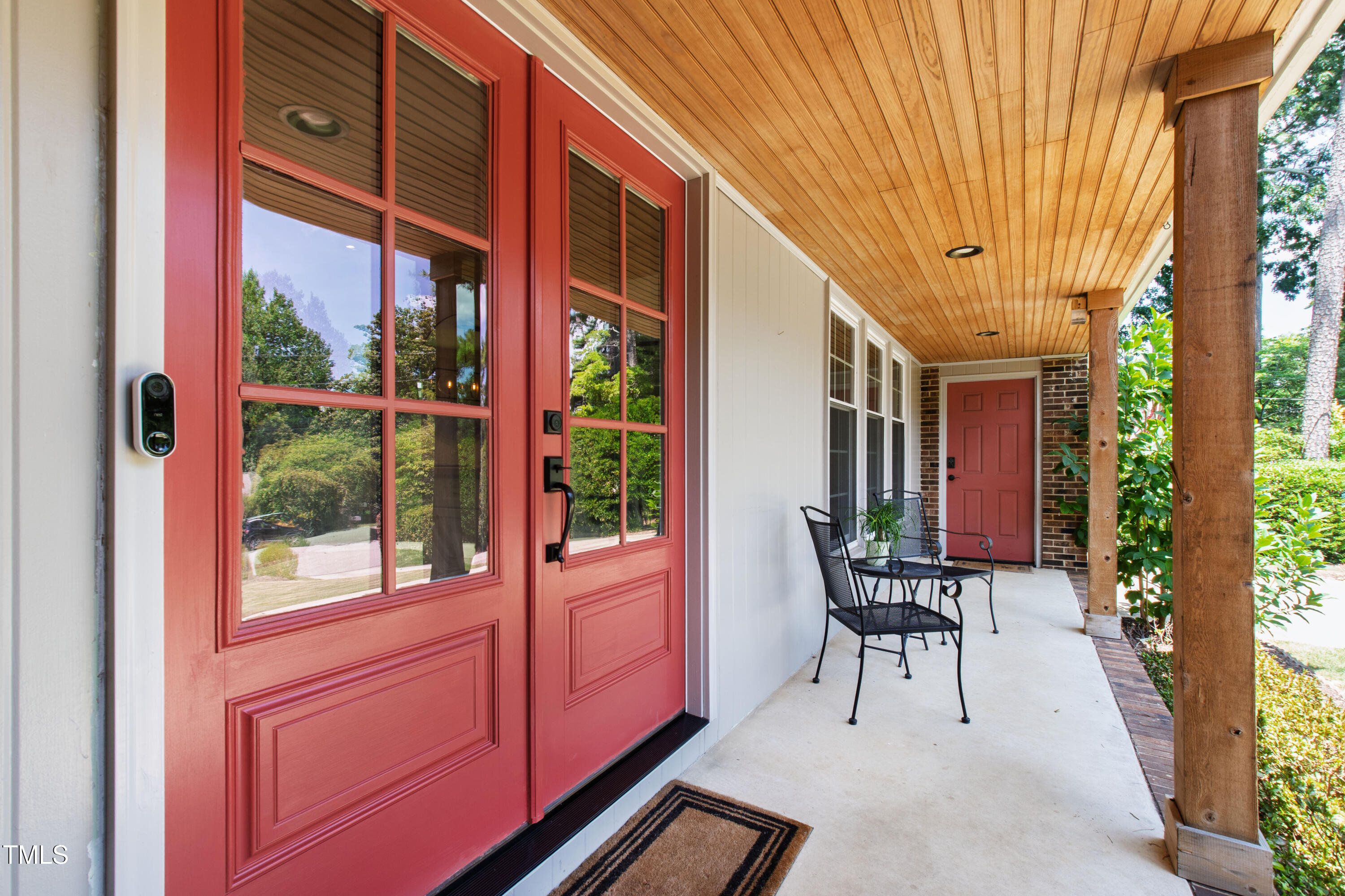 3209 Caldwell Drive Raleigh, NC 27607 - Photo 4 of 42 a porch with a table and chairs and potted plants