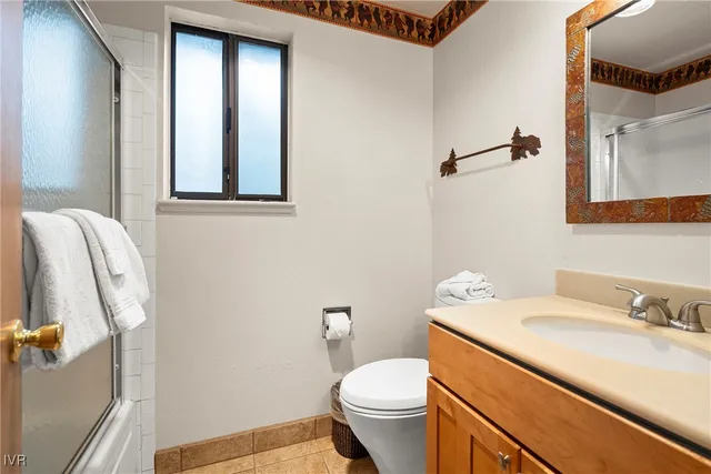 a bathroom with a sink toilet and mirror