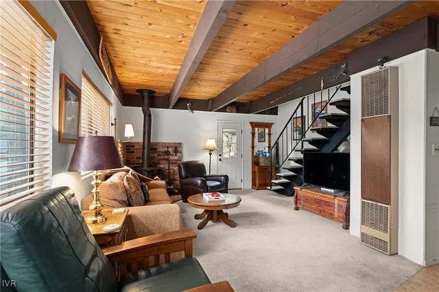 a living room with furniture a walk in closet and a window