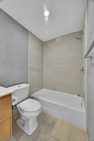a bathroom with a toilet and a bath tub