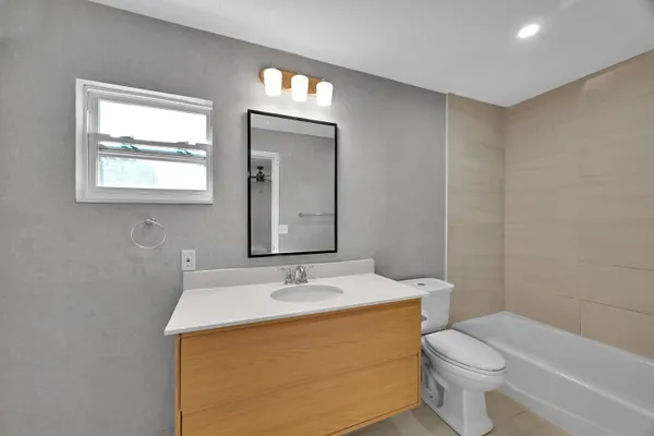 a bathroom with a sink toilet and mirror
