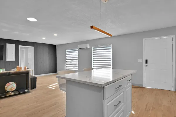 a kitchen with a wooden floor and cabinets