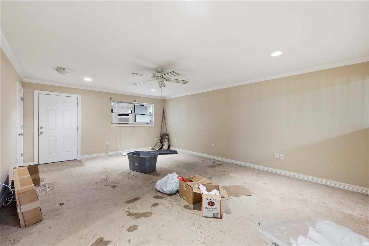 150 Gary Street Bridge City, TX 77611 - Photo 2 of 12 Spacious interior living area with neutral paint and ceiling fan.