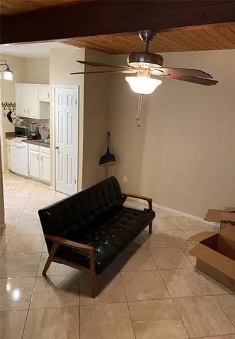 a living room with a table chairs and a chandelier