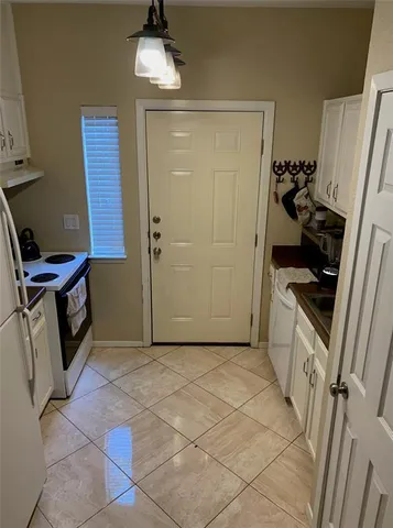 a kitchen with stainless steel appliances a stove a refrigerator and cabinets