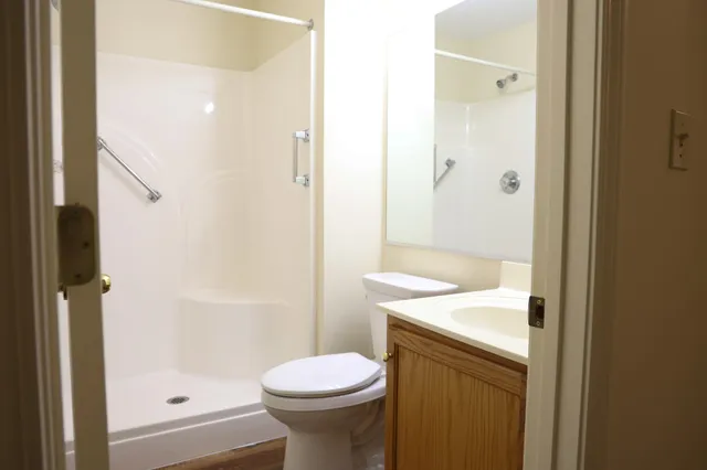 a bathroom with a sink toilet and shower