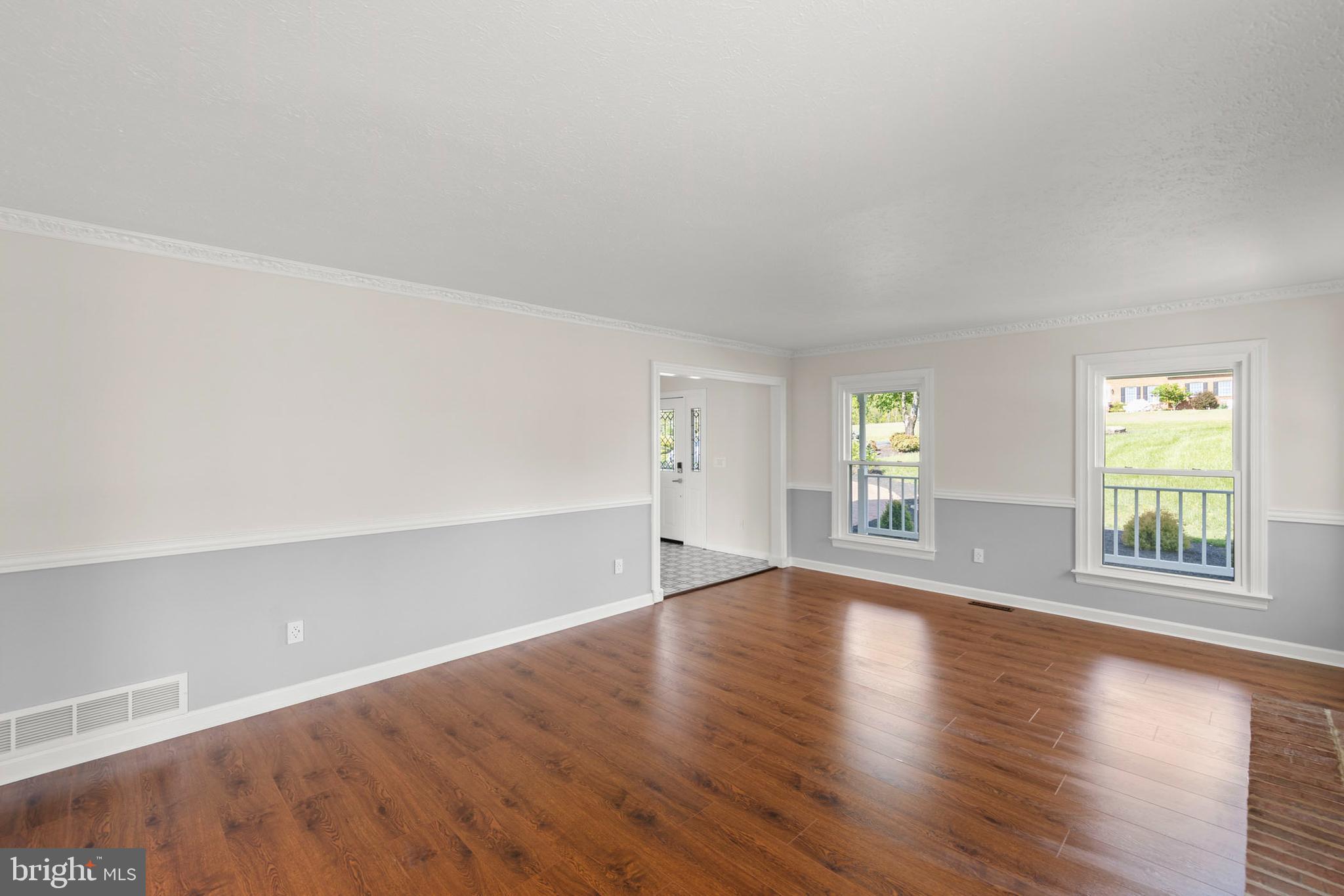 405 Spring Hollow Road Woodstock, VA 22664 - Photo 25 of 98 an empty room with wooden floor and windows
