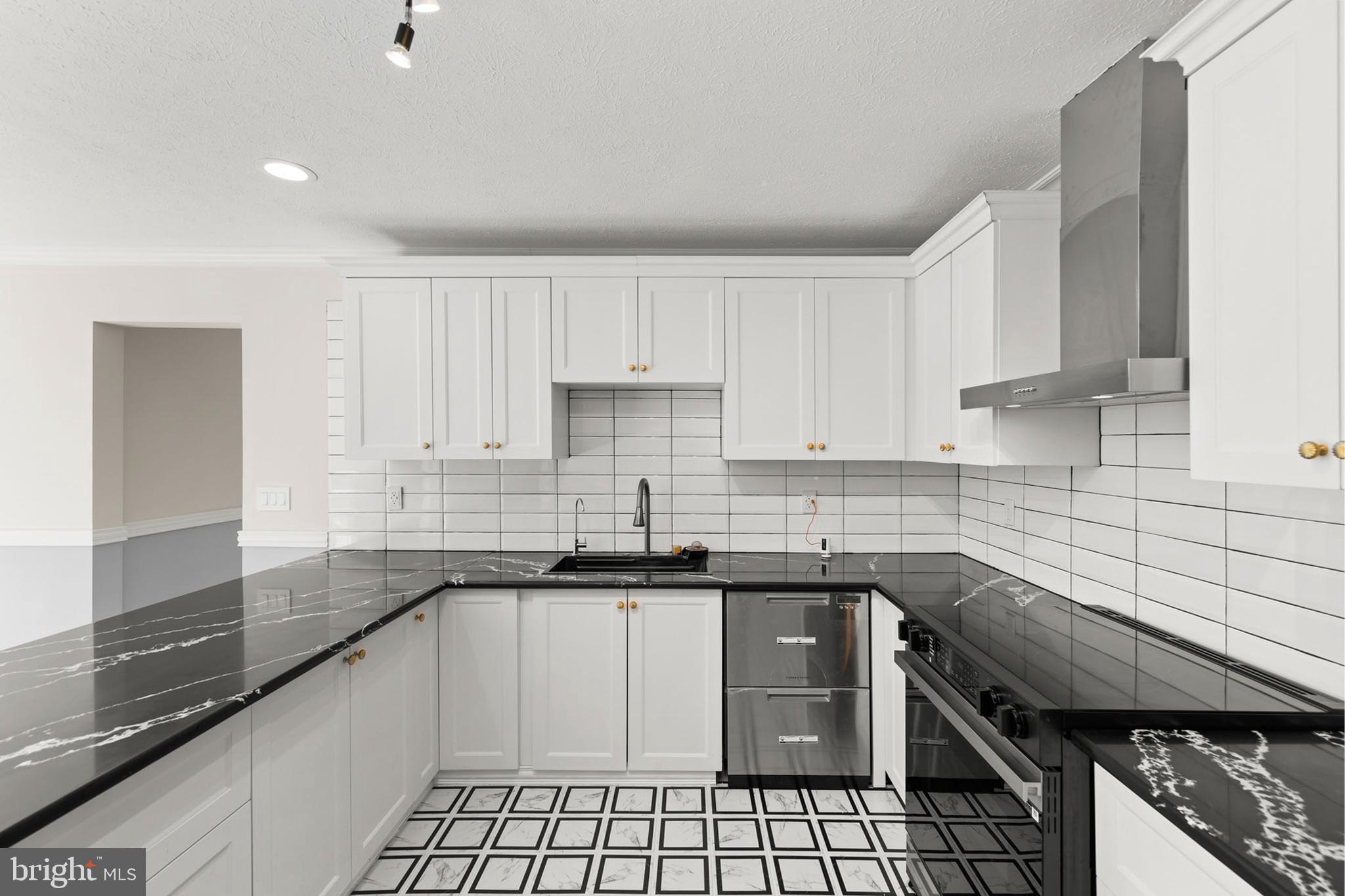 405 Spring Hollow Road Woodstock, VA 22664 - Photo 31 of 98 a kitchen with a sink a stove top oven a counter space and cabinets