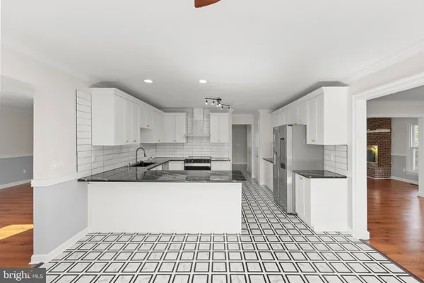 a bathroom with a toilet sink vanity and mirror