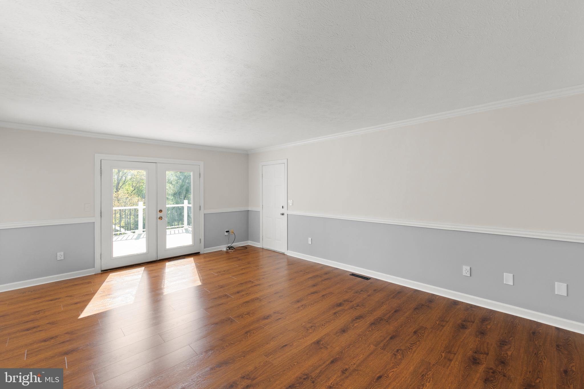 405 Spring Hollow Road Woodstock, VA 22664 - Photo 38 of 98 a view of an empty room with wooden floor and a window