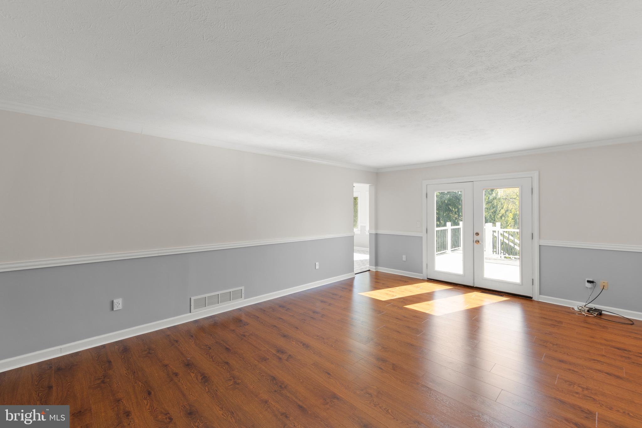 405 Spring Hollow Road Woodstock, VA 22664 - Photo 39 of 98 an empty room with wooden floor and windows