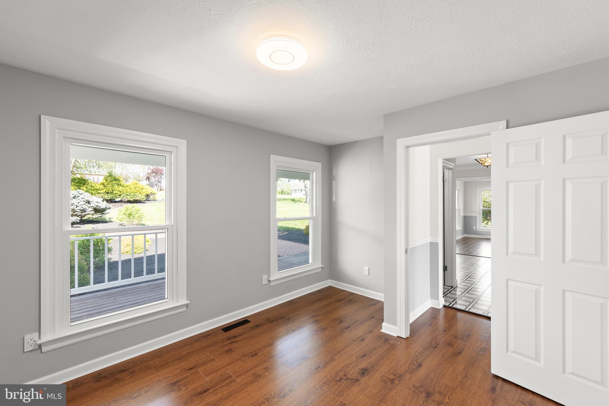 405 Spring Hollow Road Woodstock, VA 22664 - Photo 46 of 98 an empty room with wooden floor and windows