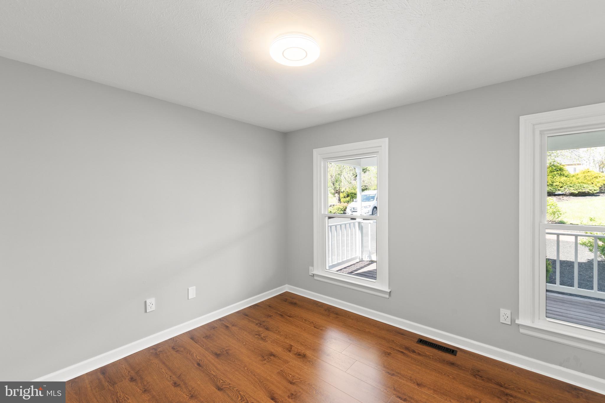 405 Spring Hollow Road Woodstock, VA 22664 - Photo 47 of 98 an empty room with wooden floor and windows