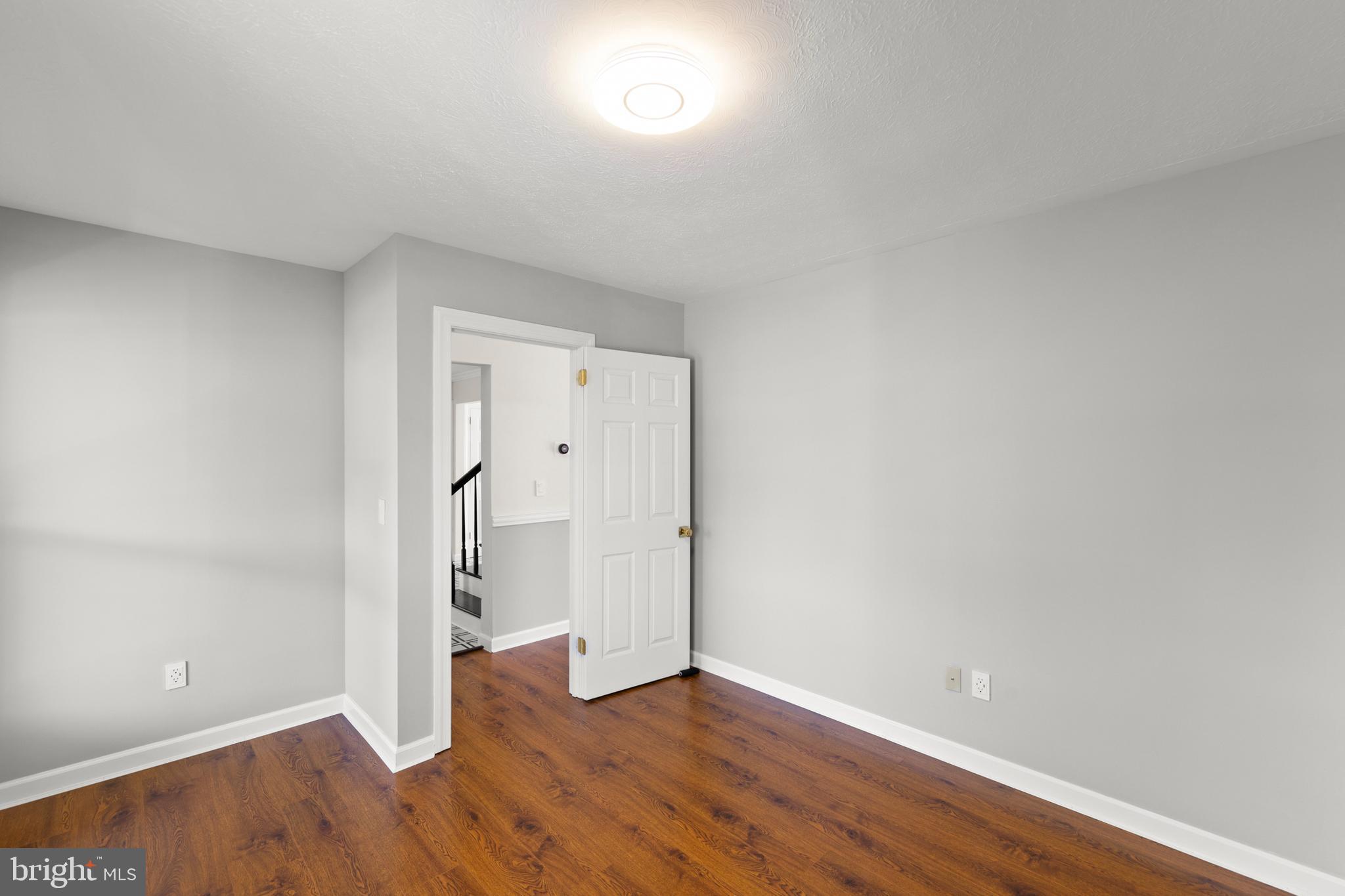 405 Spring Hollow Road Woodstock, VA 22664 - Photo 48 of 98 a view of an empty room with wooden floor