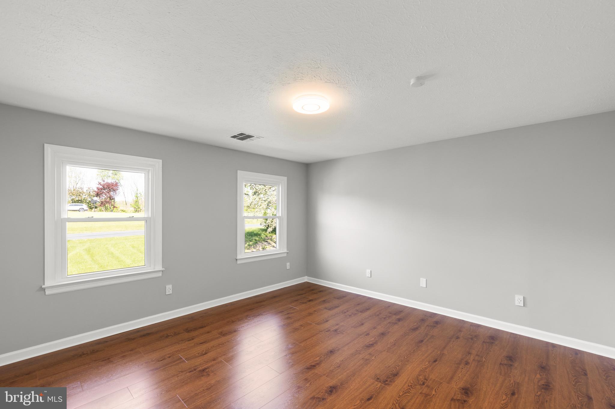 405 Spring Hollow Road Woodstock, VA 22664 - Photo 49 of 98 a view of an empty room with wooden floor and a window