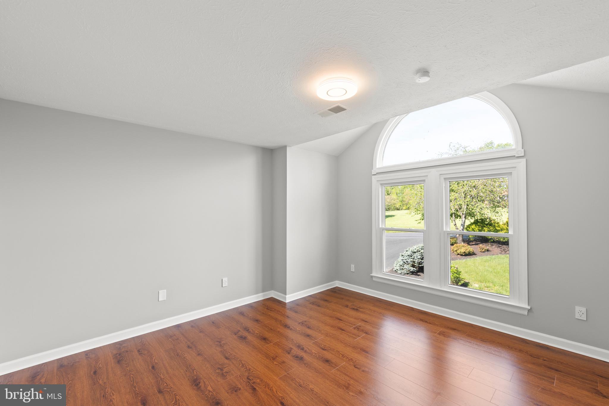 405 Spring Hollow Road Woodstock, VA 22664 - Photo 52 of 98 an empty room with wooden floor and windows