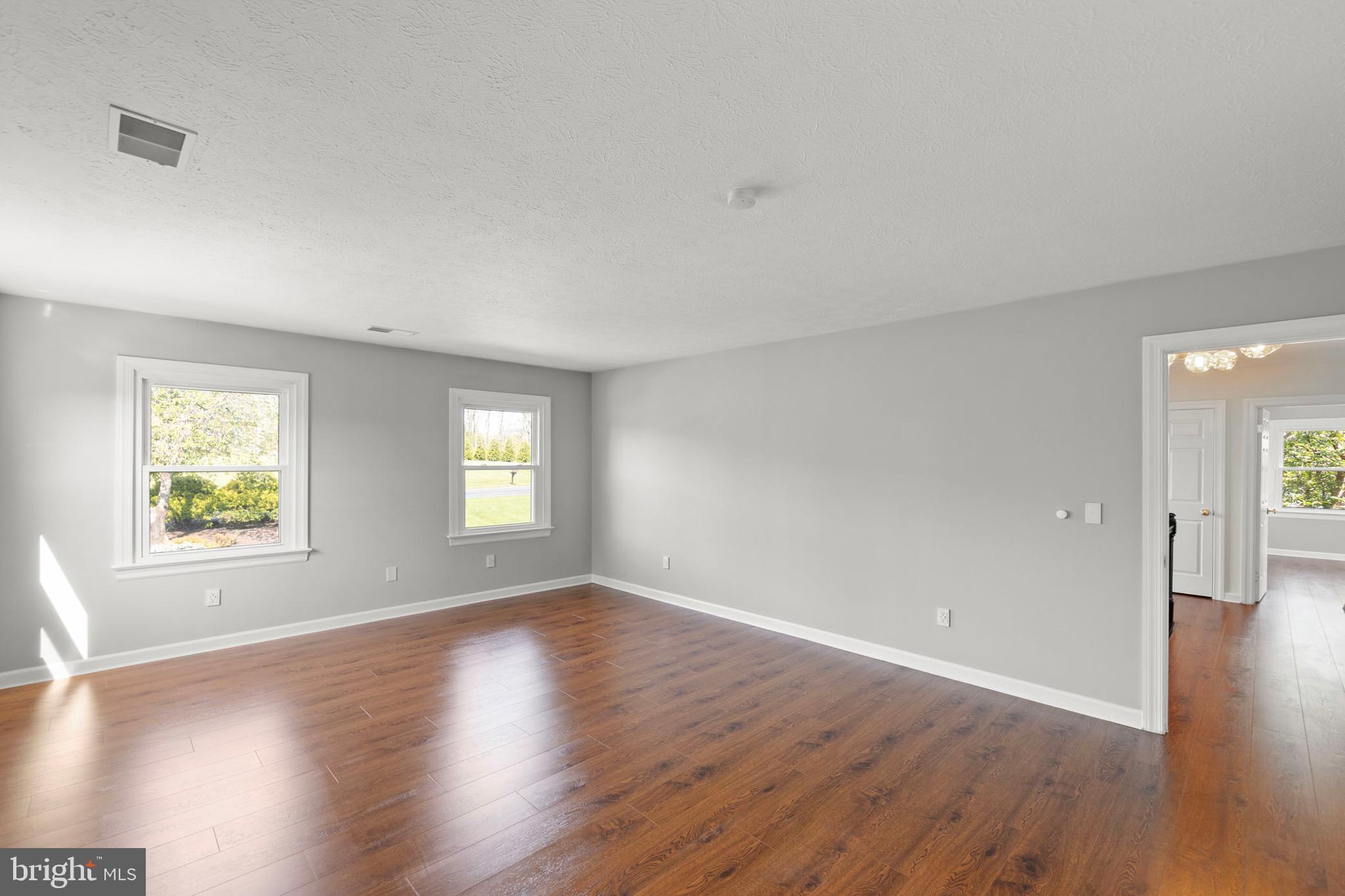 405 Spring Hollow Road Woodstock, VA 22664 - Photo 62 of 98 an empty room with wooden floor and windows