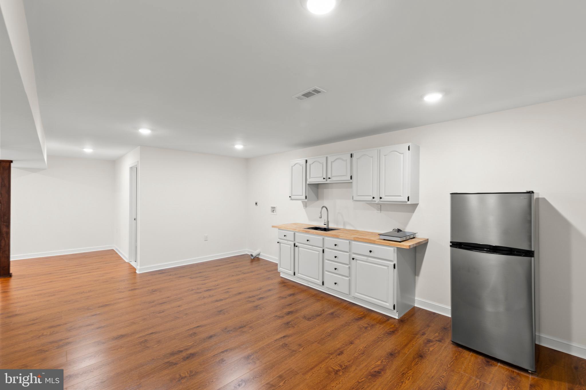 405 Spring Hollow Road Woodstock, VA 22664 - Photo 66 of 98 a kitchen with stainless steel appliances granite countertop a refrigerator a stove a sink and white cabinets with wooden floor