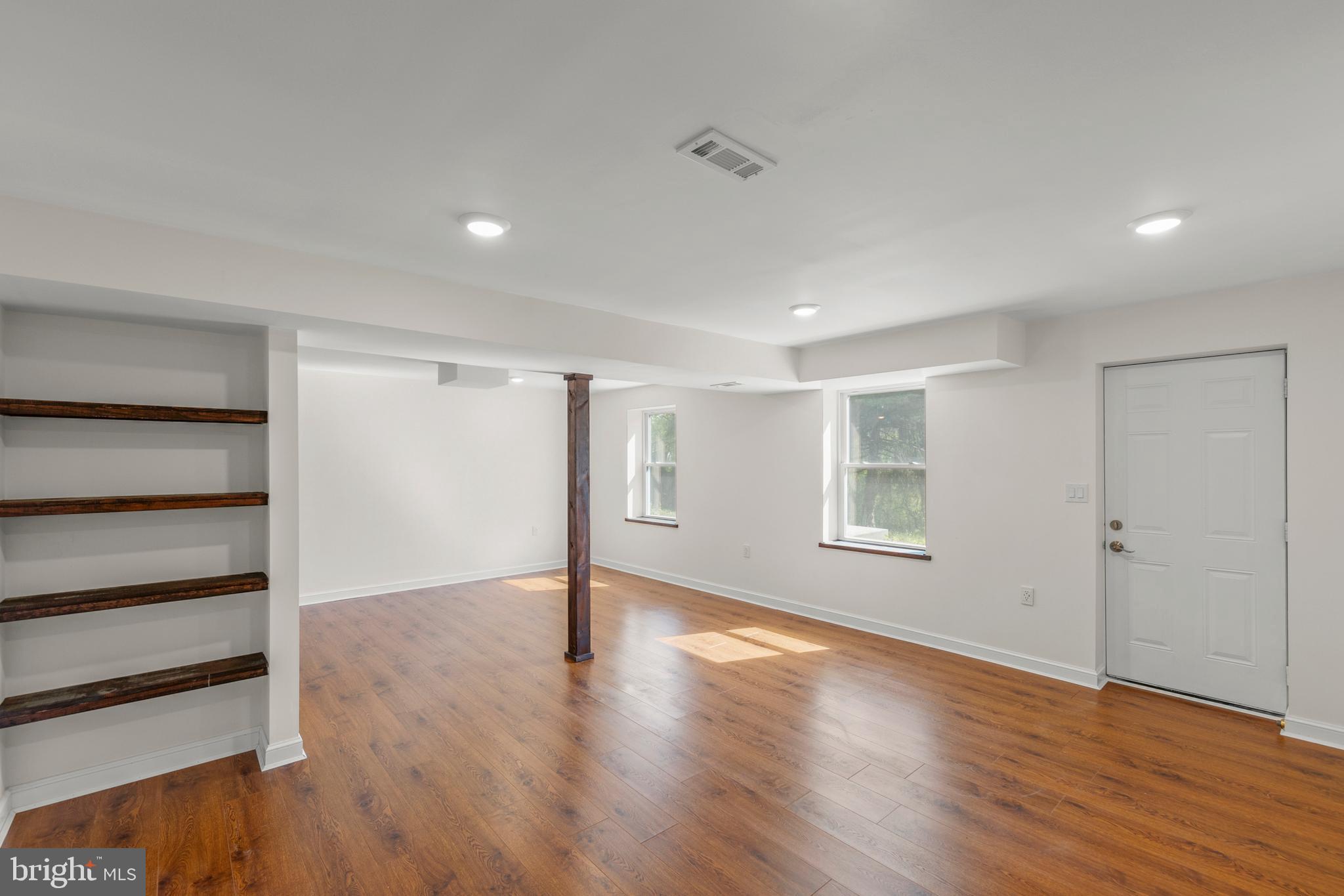 405 Spring Hollow Road Woodstock, VA 22664 - Photo 74 of 98 a view of an empty room with wooden floor and a window