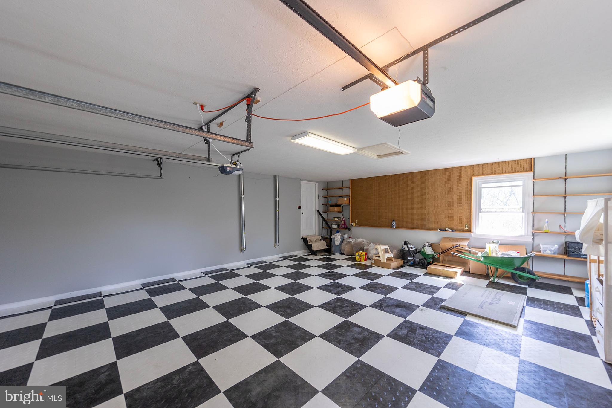 405 Spring Hollow Road Woodstock, VA 22664 - Photo 77 of 98 a living room with a black white checkered floor with couches chair and a coffee table