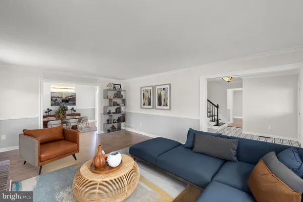 an empty room with wooden floor fireplace and windows